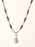 Gold-plated necklace with purple amethyst beads, pink pearls, and iridescent baroque pearl pendant beneath crystal star charm
