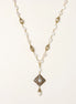 Elegant 14K gold plated necklace with freshwater pearls and ornate crystal diamond pendant on cream background.