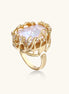 Ornate gold-plated ring with large baroque pearl in decorative vine-like setting with small crystal accents