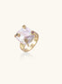 Gold-plated ring featuring large baroque freshwater pearl with small colorful gemstone accents on textured band