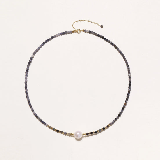 Dainty necklace with faceted purple iolite beads, gold vermeil accents, and central pink-white freshwater pearl.