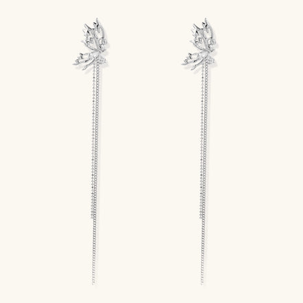 Long gold-plated earrings with star motifs and delicate chain tassels cascading down, featuring zirconia accents.