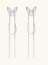 Delicate drop earrings with clear crystal butterfly tops and long metallic chain dangles on white background.