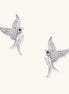 Pair of gold-plated hummingbird earrings with crystal pavé wings and black stone eyes on neutral background.