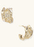 Close-up of gold-plated brass hoop earrings with geometric lattice pattern and sparkling zirconia stones