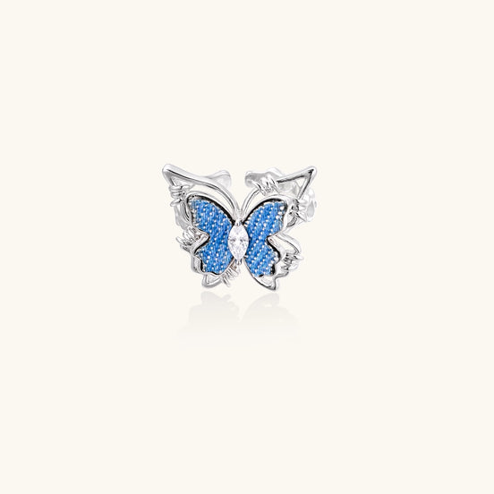 Gold-plated brass ring featuring blue butterfly design with central zirconia stone on neutral background.
