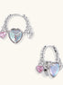 Gold-plated brass hoop earrings with three heart charms including iridescent turquoise and pink hearts on white background.