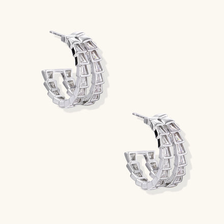 Gold-plated huggie hoops featuring vertical rows of clear baguette zirconia stones in geometric linear design