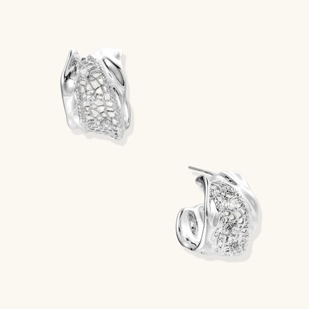 Small gold-plated brass hoop earrings with geometric lattice pattern and zirconia accents on white background.