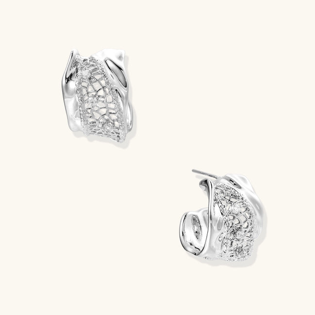 Small gold-plated brass hoop earrings with geometric lattice pattern and zirconia accents on white background.