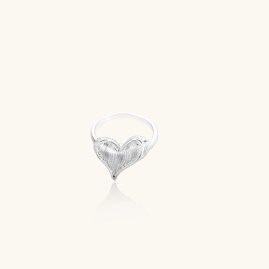 18K gold plated brass ring with intricate feather design forming a heart shape on white background.