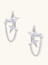Delicate gold-plated star earrings with sparkling zirconia crystals connected by fine chains on cream background.