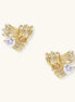 Close-up of gold-plated twisted rope design stud earrings with clear zirconia crystals on white background.