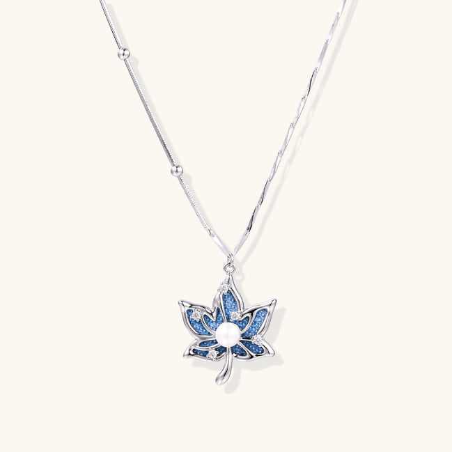 Gold-plated lotus pendant necklace with blue zirconia stones and white beads on adjustable layered chains
