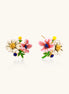 Detailed view of gold-plated brass stud earrings featuring multicolor enamel flowers with white, pink, and blue petals
