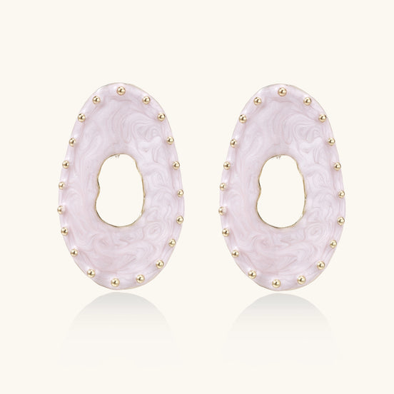 Oval lavender enamel earrings with gold studs around perimeter and cutout centers on white background