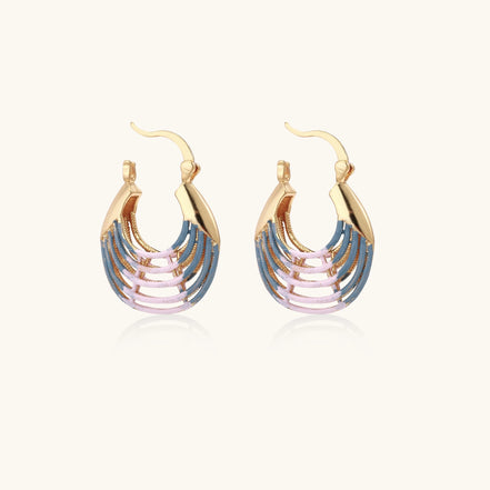 Gold hoop earrings with layered blue to pink enamel in shell pattern, photographed against white background