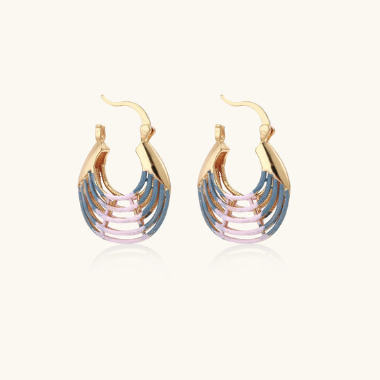 Gold hoop earrings with layered blue to pink enamel in shell pattern, photographed against white background