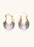 Gold hoop earrings with layered blue to pink enamel in shell pattern, photographed against white background