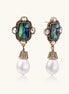 Gold-plated brass drop earrings featuring iridescent abalone shell centers, crystal accents, and white pearl drops.