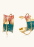 Gold-plated hoop earrings with colorful enamel brushstroke patterns in turquoise, coral, and gold tones