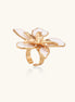 Gold-plated adjustable ring with large white enamel flower design featuring smooth petals outlined in gold