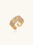 Bold geometric ring with lattice pattern in gold-plated brass featuring multiple tiers of sparkling zirconia stones