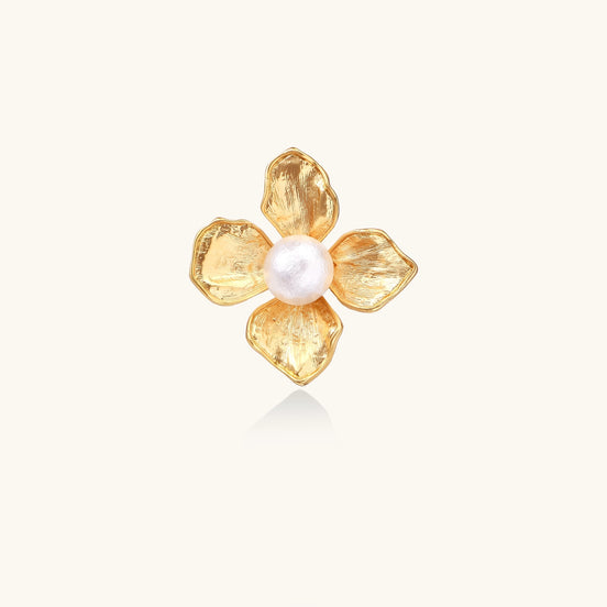 Gold-plated brass ring with dimensional 5-petal flower design and white cotton pearl center on neutral background.