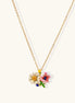 Delicate gold-plated necklace featuring white daisy and pink flower enamel pendant with colorful accents on white background.