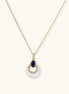 Layered pendant necklace with deep blue lapis lazuli stone, crystals, and white mother of pearl on 18k gold plated chain