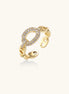 Gold-plated brass chain-link ring with cubic zirconia oval centerpiece, showing adjustable open-back design.