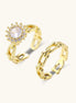 Two gold-plated rings with cubic zirconia halo design and chain-link band on white background, adjustable sizing.