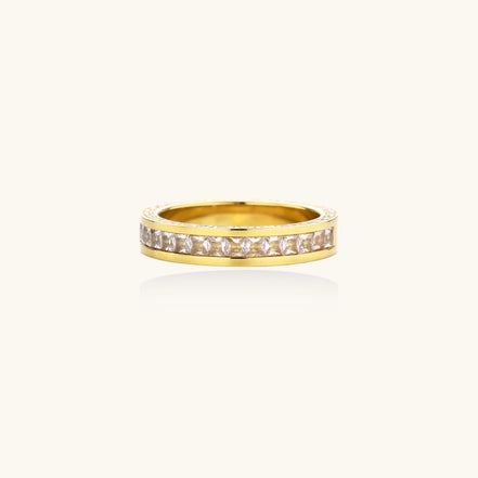 14K gold plated ring with channel-set zirconia stones and Greek key pattern engraved on sides on white background