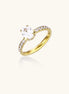 14K gold-plated ring with oval zirconia center stone and pavé band accent stones on white background.