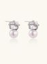 Gold-plated stud earrings with square crystal tops wrapped in twisted wire and freshwater pearl drops on white background