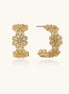 Ornate gold-plated brass hoop earrings featuring delicate floral filigree patterns and intricate rosette details.
