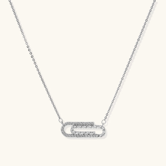 Delicate 14K gold plated chain necklace with crystal-accented carabiner-style pendant on white background