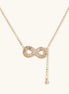 Delicate 14K gold plated infinity pendant with crystal accents on adjustable chain with small ball charm detail.