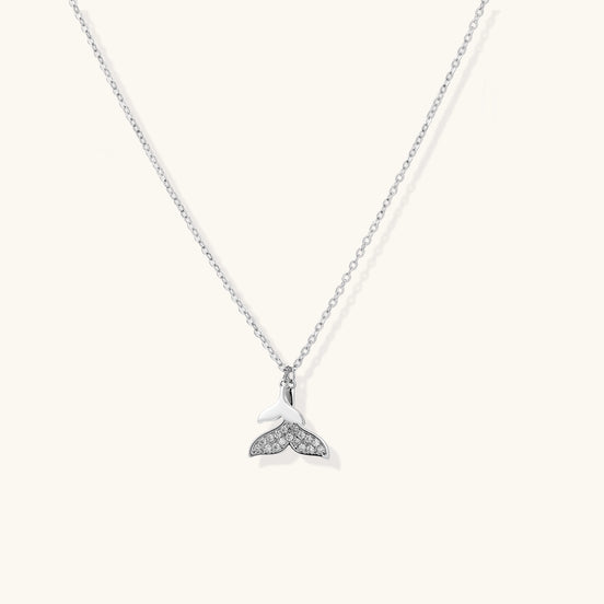 Delicate 14K gold-plated whale tail pendant necklace with sparkling crystal details on fine chain against white background.