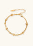 Delicate 18K gold plated bracelet with spherical beads on layered chains and adjustable extender on white background