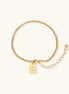Minimalist gold-plated stainless steel chain bracelet with rectangular 'Good Luck' charm and adjustable extension