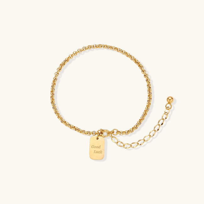 Minimalist gold-plated stainless steel chain bracelet with rectangular 'Good Luck' charm and adjustable extension