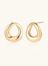 Pair of polished 18K gold-plated stainless steel oval loop stud earrings on cream background