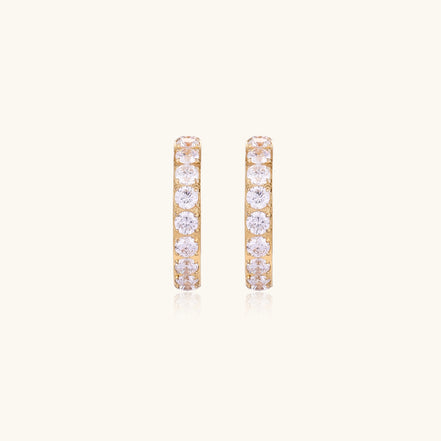 Gold-plated hoop earrings with crystal pavé and floating freshwater pearls inside the circular design.