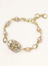 Gold-plated bracelet with pink baroque pearl centerpiece, floral connector, and freshwater pearls