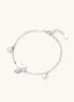 Delicate rhodium-plated silver chain bracelet with butterfly charm and two freshwater pearls on cream background