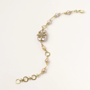 Gold-plated bracelet with pink baroque pearl centerpiece, floral connector, and freshwater pearls