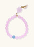 Stretchy beaded bracelet with pink rose quartz, blue aquamarine, carved floral pendant, and pearl tassel clasp.