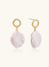 18K gold vermeil twisted circle studs with organic white baroque pearl drops on cream background