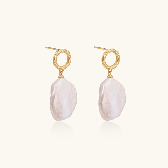 18K gold vermeil twisted circle studs with organic white baroque pearl drops on cream background